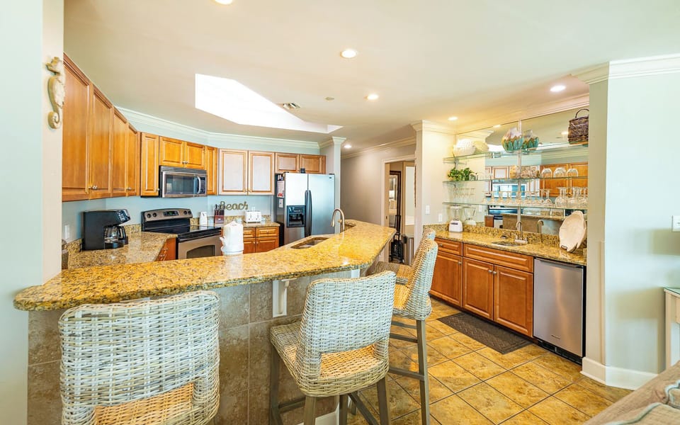 Relax and get ready for a beach day at the kitchen's granite breakfast bar where you sip morning coffee