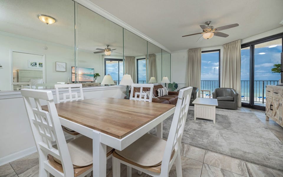 Gather around the dining table for meals while enjoying the inviting atmosphere and beach views through large windows