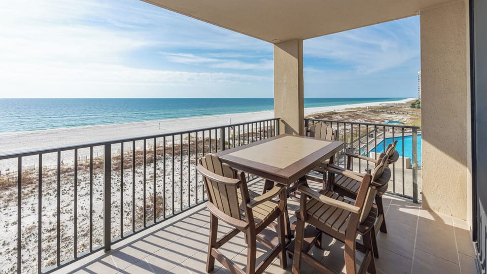 Enjoy meals or drinks at the outdoor table while taking in the expansive views of the tranquil water and beach