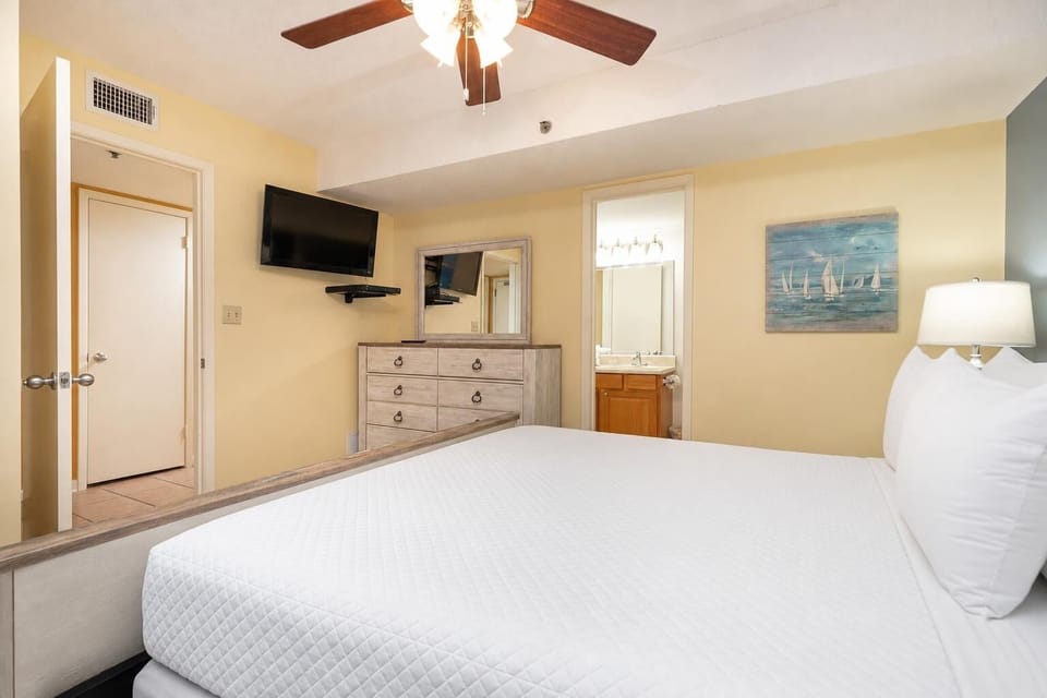 Cozy bedroom featuring a king bed, flat-screen TV, and a warm color palette for a relaxing getaway