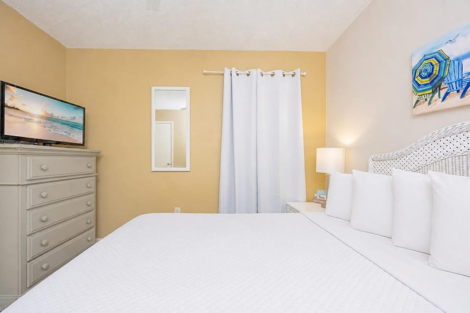 Sleep soundly in your queen guest suite where gentle lamplight and coastal art calm your mind before rest