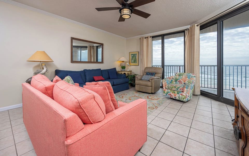 Relax in the inviting living area with colorful seating, sofa with queen sleeper, and beachfront balcony access