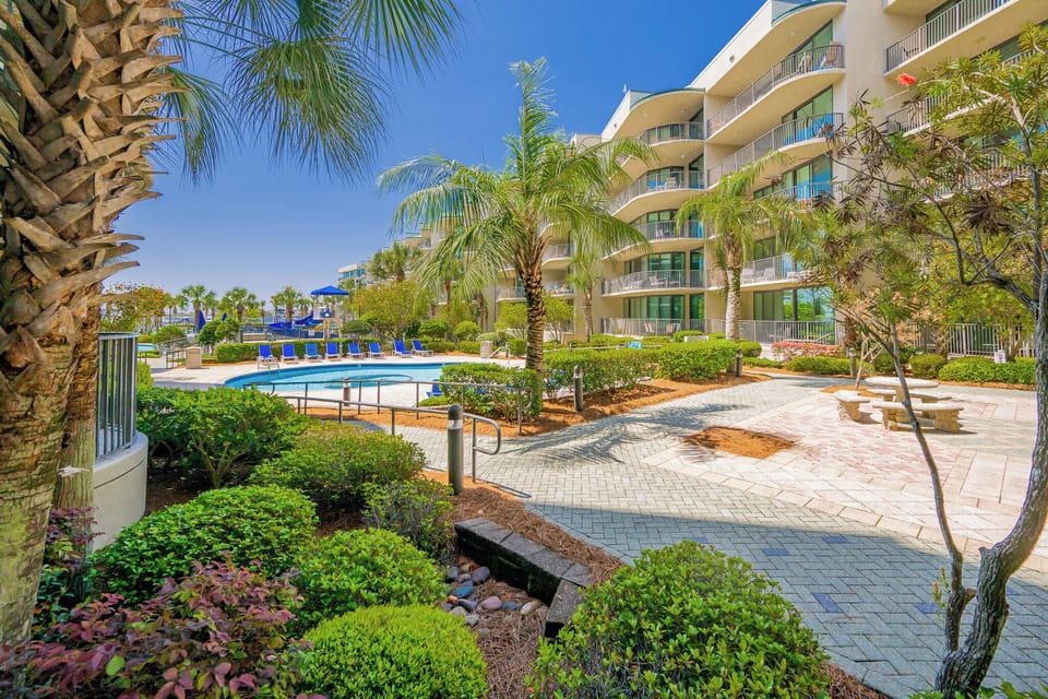 Relax amid lush greenery and the inviting pool area, soaking up the sunshine and coastal vibes