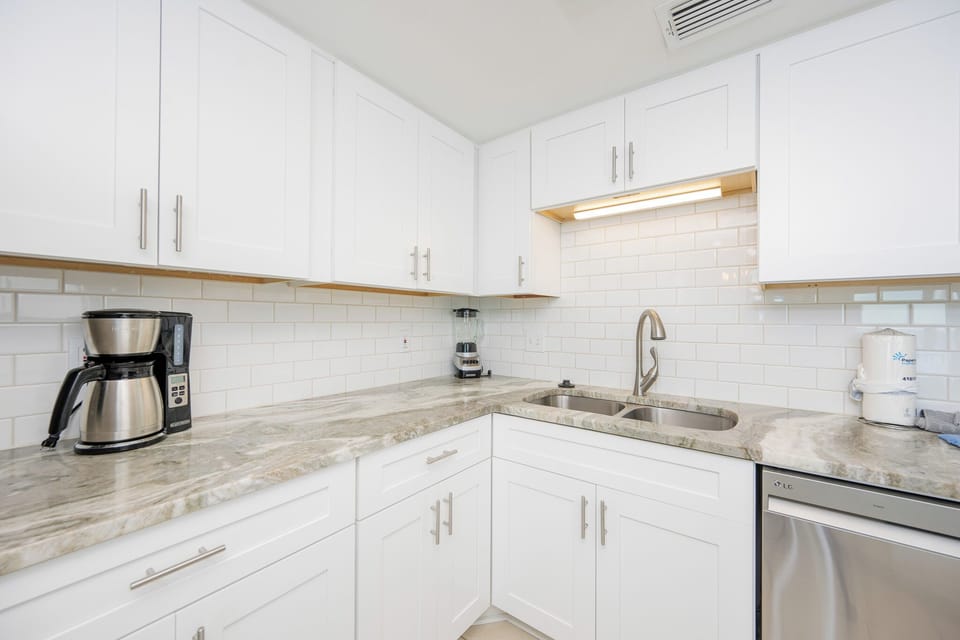 Craft delicious meals in this stylish kitchen featuring sleek countertops and modern design
