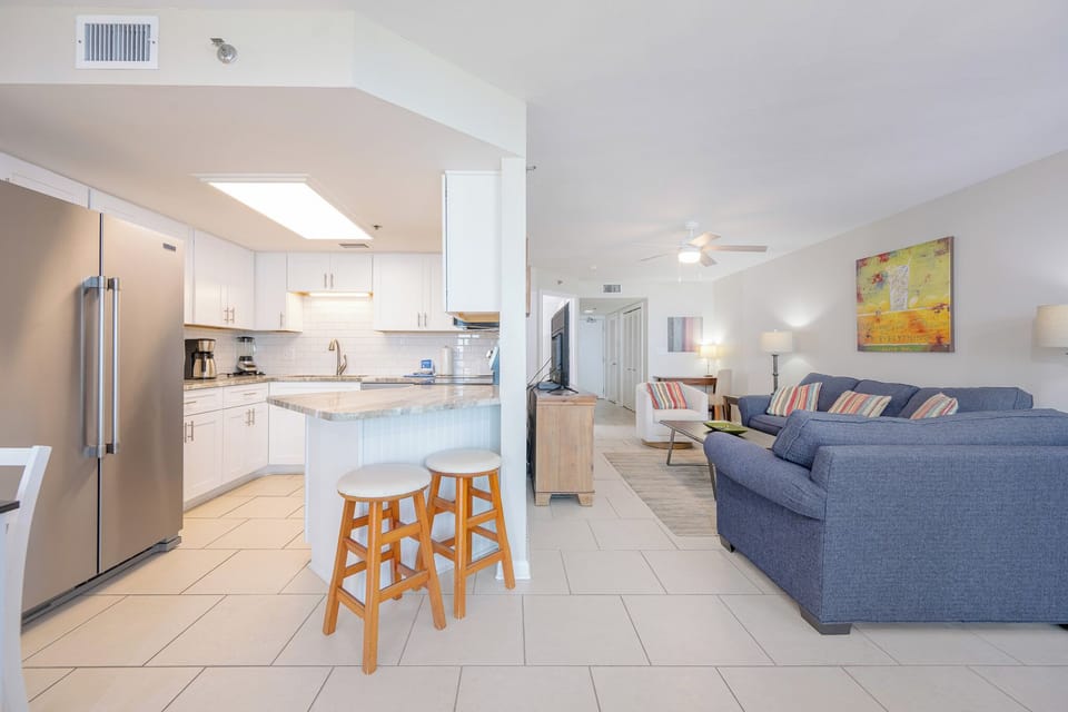 Enjoy preparing meals in this modern kitchen while relaxing in the inviting living area with comfortable seating
