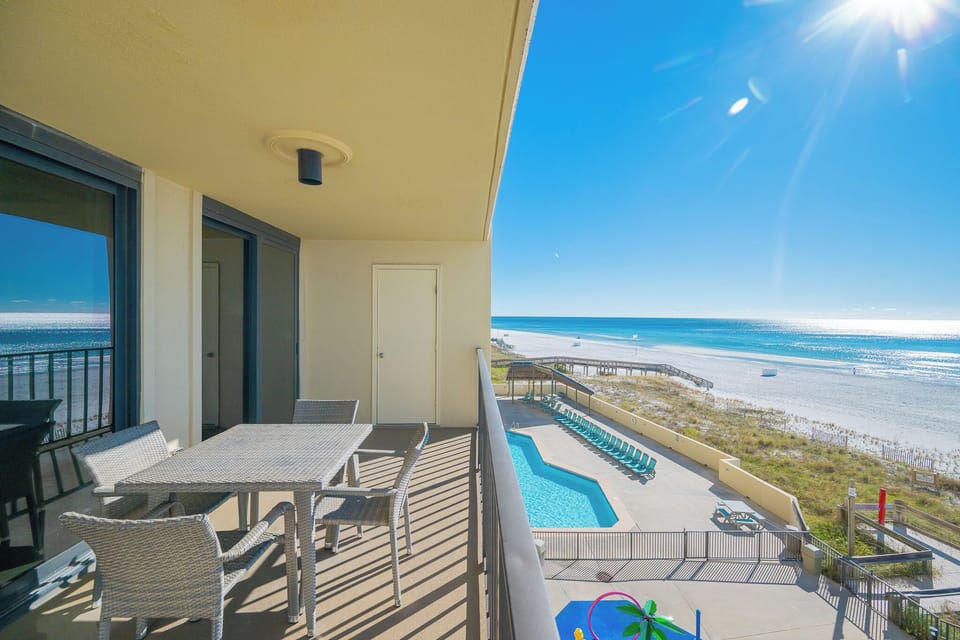 Relax and unwind on your balcony, soaking in stunning views of the coast and pool while enjoying the warm sunshine