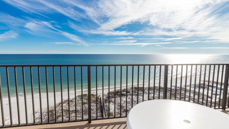 Enjoy breathtaking views of the turquoise water and shoreline from your spacious balcony