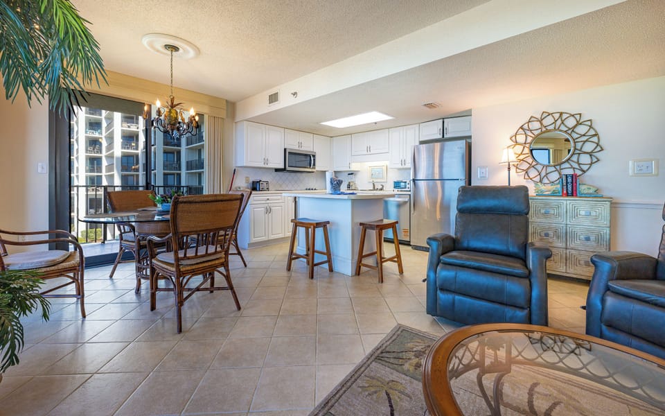 Share laughter around the inviting dining table while admiring the beach vibe through the expansive windows