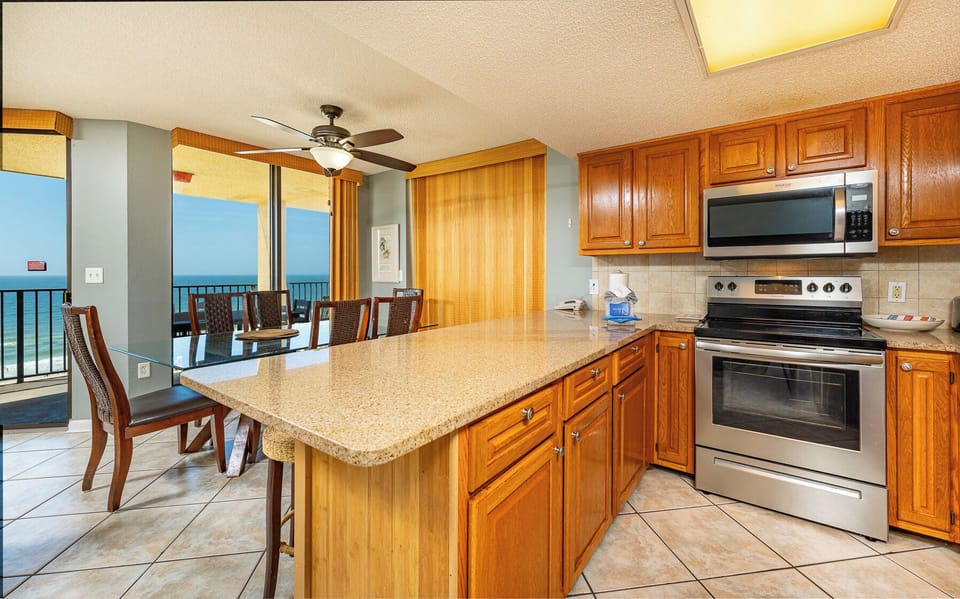 Your kitchen counter invites lively conversations while the gulf coast stretches beyond the balcony doors