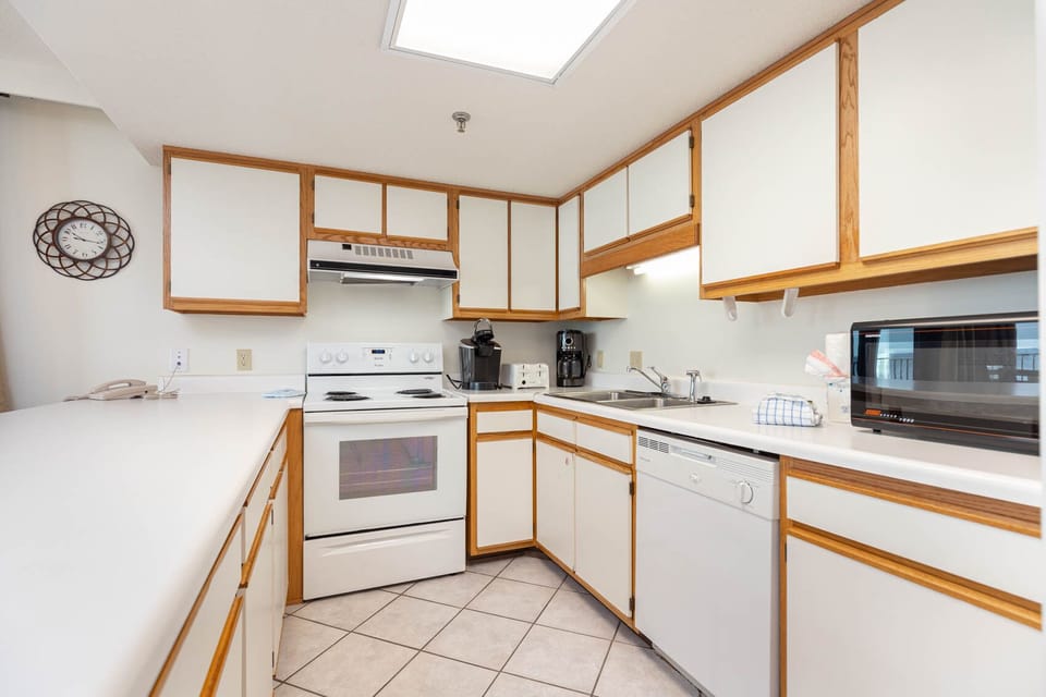 Bright kitchen featuring white cabinetry, a full range of appliances, and a convenient layout for meal preparation