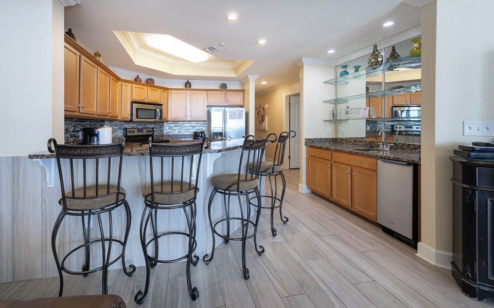 Enjoy casual conversations from the stylish bar seating while sipping your favorite drink in this inviting kitchen