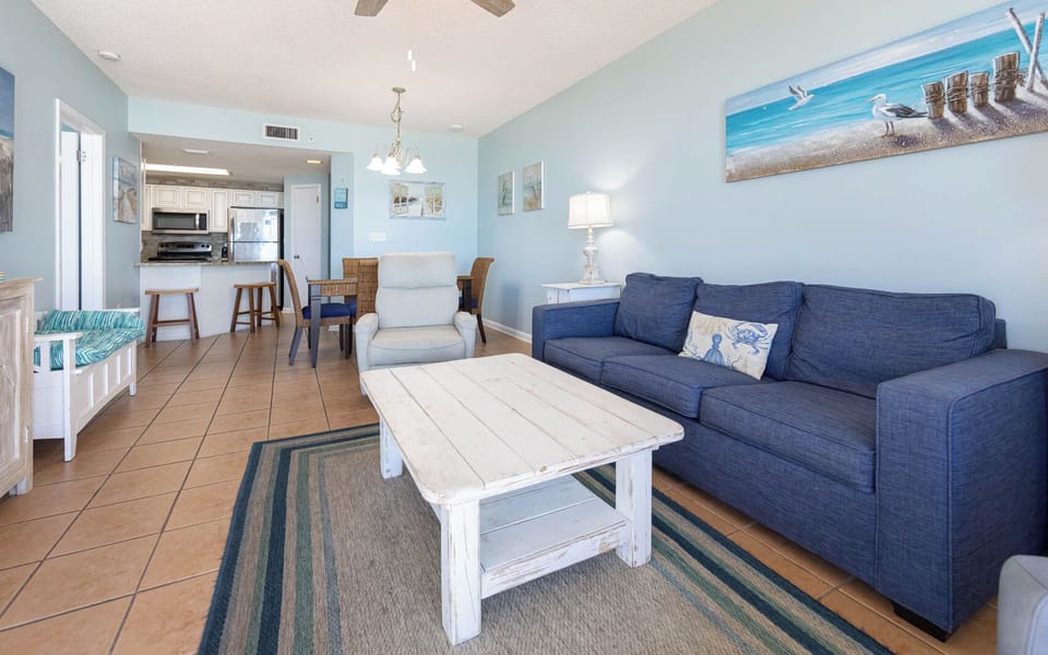 Relax in the spacious living area with a comfortable sofa with queen sleeper, coffee table, and inviting décor