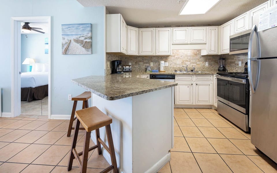 Cook meals in the bright kitchen featuring granite countertops, stainless appliances, and a welcoming atmosphere