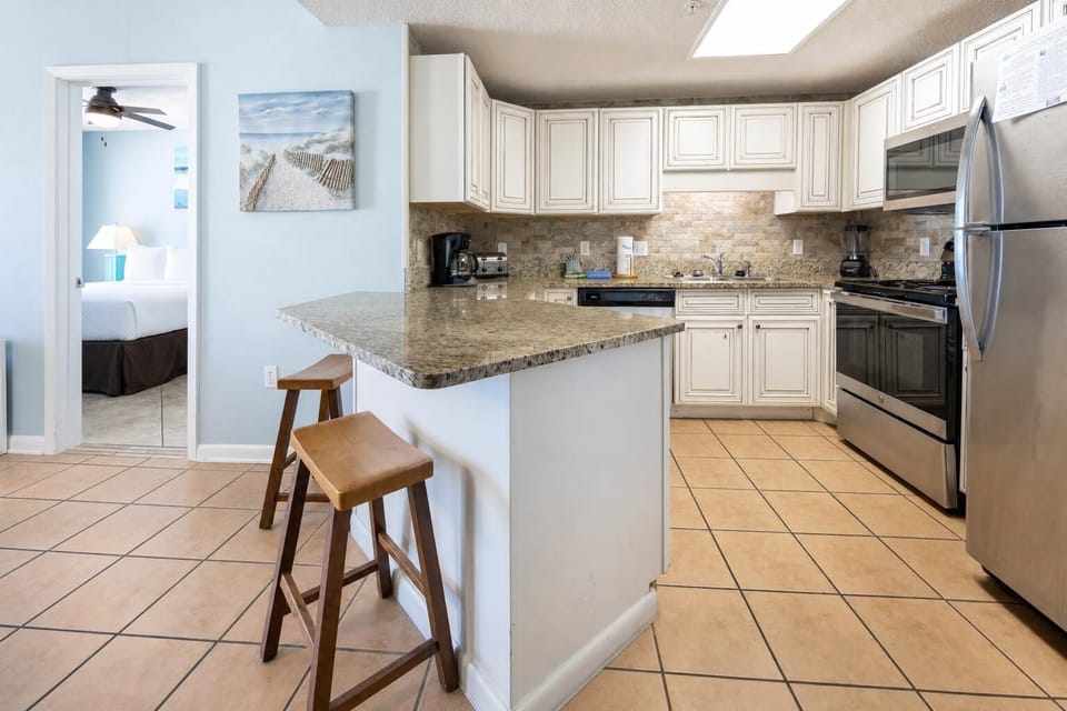 Cook meals in the bright kitchen featuring granite countertops, stainless appliances, and a welcoming atmosphere