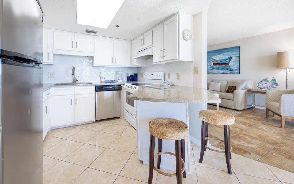 Gather around the kitchen bar, perfect for casual meals and conversations in a welcoming atmosphere