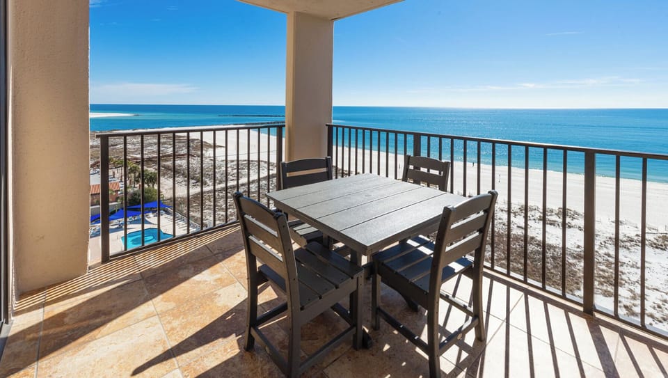 Enjoy time on the balcony overlooking the tranquil waters and beach