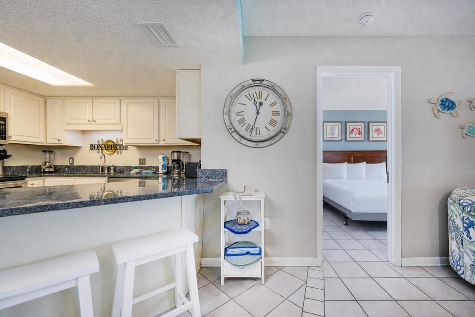 Bright kitchen with breakfast bar invites you to prepare fresh meals before retreating to the master suite with a king bed