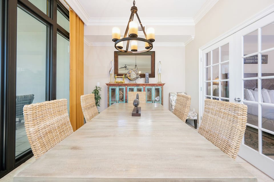Gather around the large dining table, sharing laughter and stories in a welcoming coastal vibe with stunning decor
