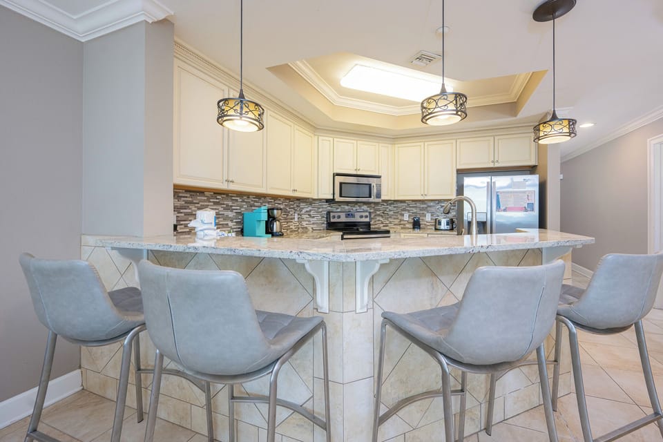 Gather around the stylish bar seating to enjoy casual conversations and a warm drink while whipping up snacks