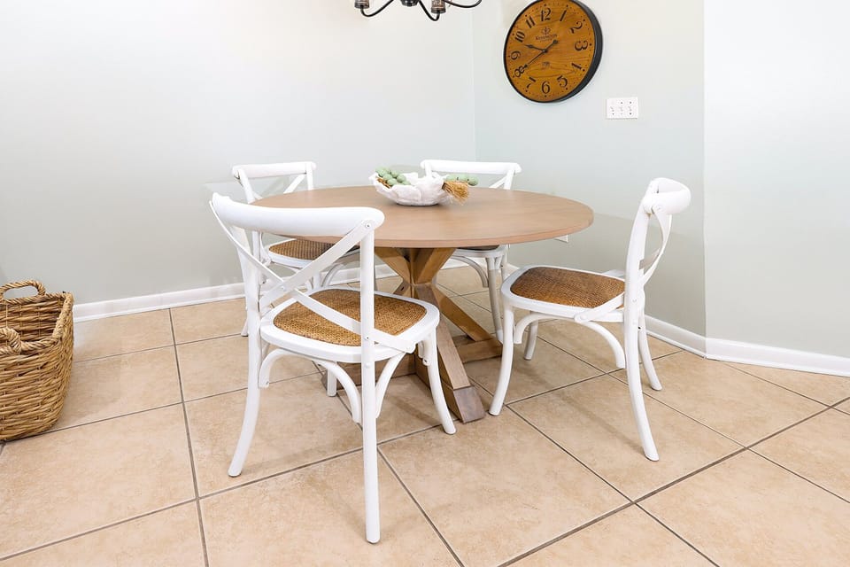 Gather around the round dining table with stylish white chairs, perfect for meals or games during your stay