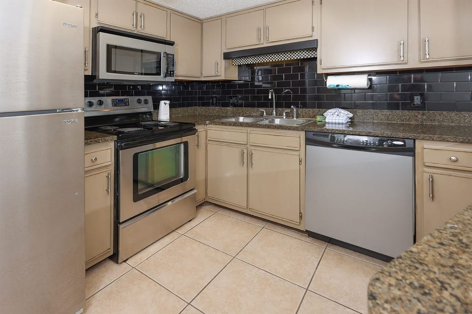 Cook with ease in the stylish kitchen featuring stainless appliances, granite countertops, and ample storage space
