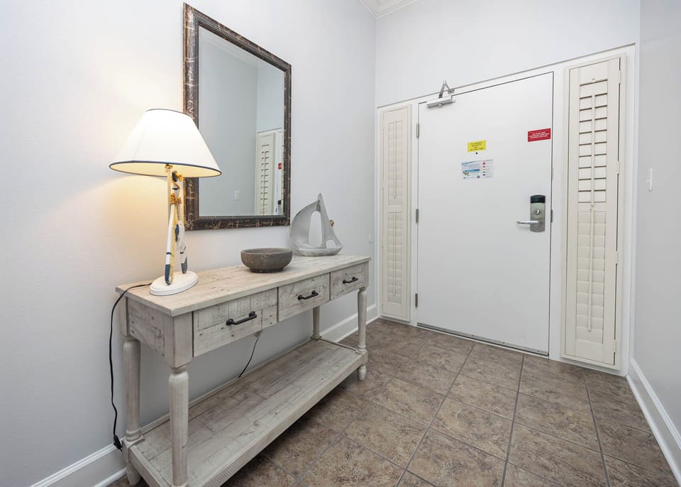 Step into this welcoming entryway, where serene decor sets the tone for your relaxing beach getaway