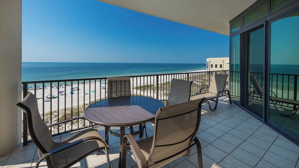 Relax on the private balcony with inviting seating and breathtaking views of the pristine beach and tranquil waters