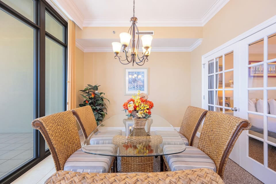Savor quality time as you gather around the glass dining table, sharing laughter and making memories in this inviting space