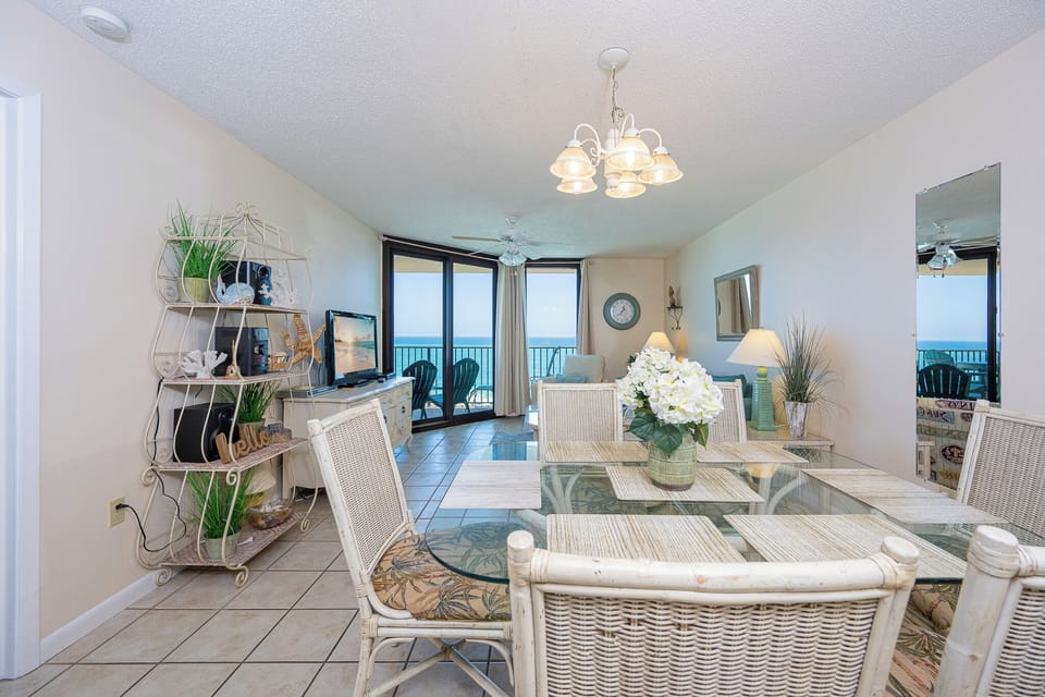 Enjoy meals at the glass dining table, surrounded by tropical decor and beachfront views