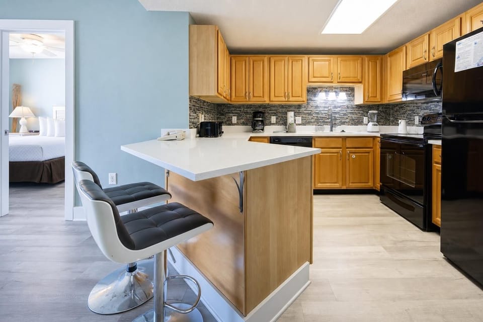 Prepare meals and gather around the kitchen featuring a sleek design with black appliances