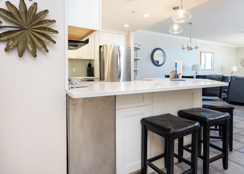 Enjoy casual meals at the sleek kitchen bar with seating for four, perfect for gathering and conversation