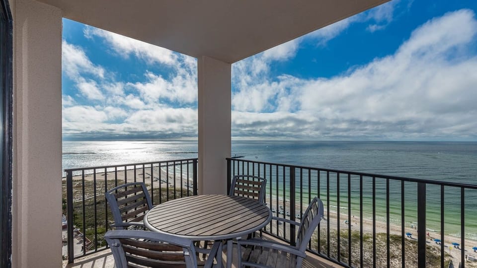 Enjoy time on the balcony while taking in the expansive views of the shimmering water and beach