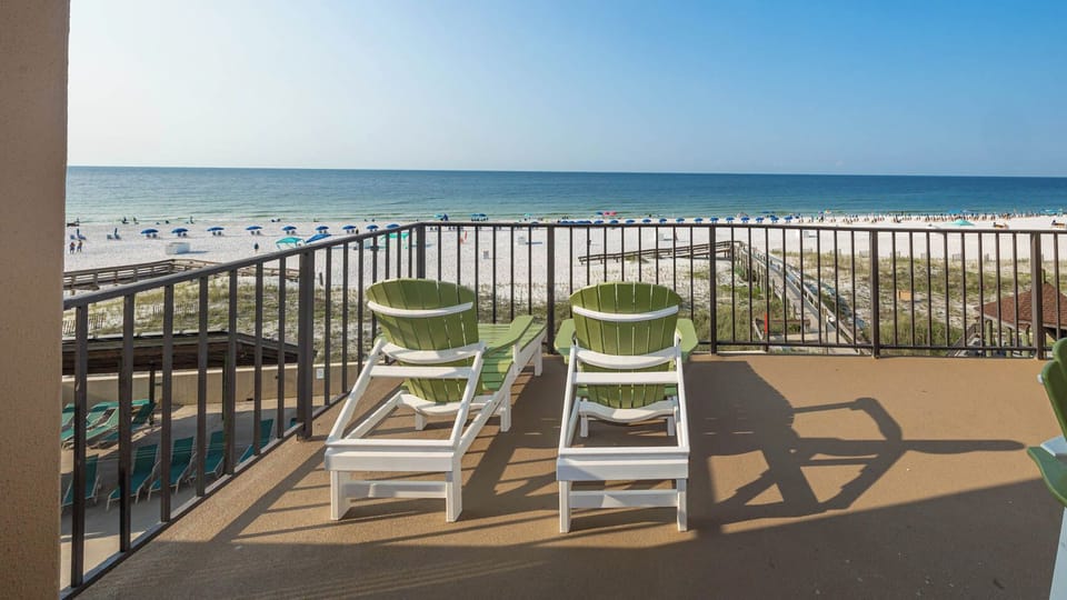 Relax in your lounge chairs on your extended balcony and soak in the serene views of the beach and vibrant coast life