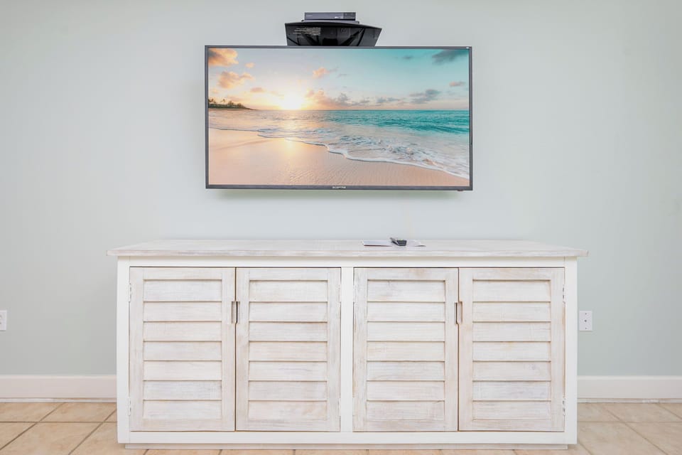Stream your favorite shows while relaxing in this inviting living space, soaking in the coastal ambiance