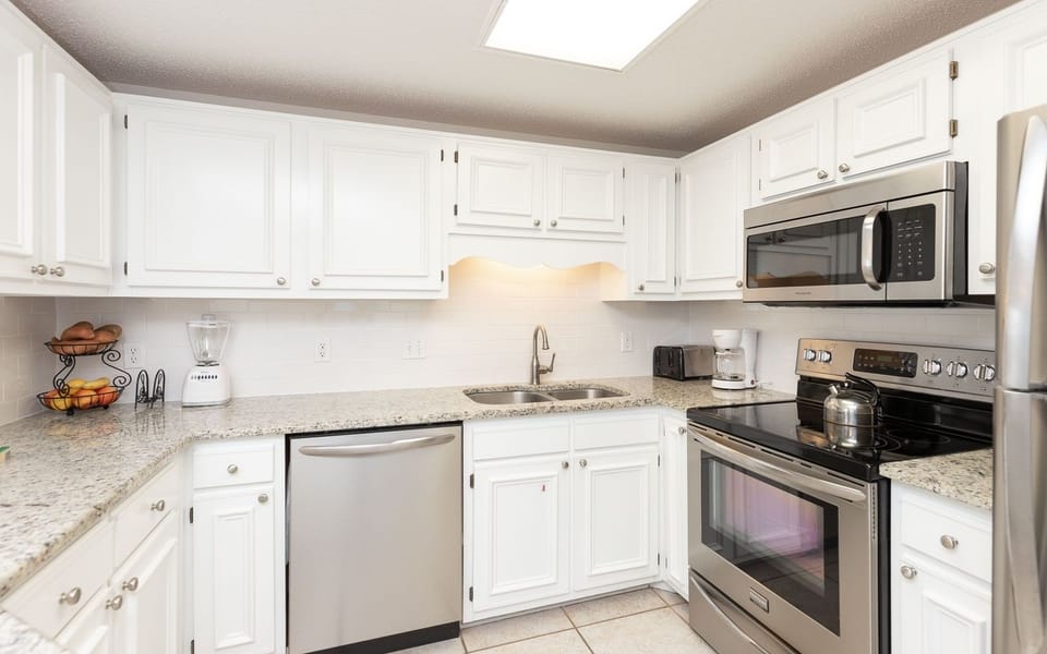 Stainless appliances and granite countertops in this inviting kitchen, featuring a blender and coffee maker
