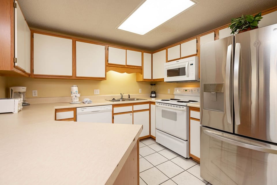 Prepare meals in this functional kitchen featuring ample counter space and a bright atmosphere