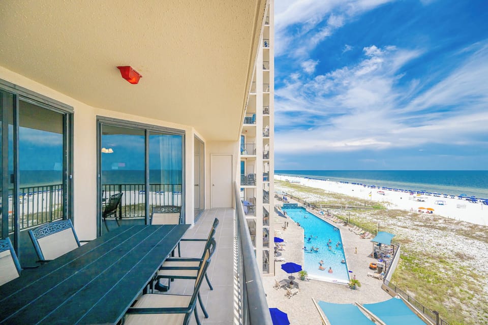 Dine at the outdoor table while enjoying refreshing coastal breezes and views of the beach below