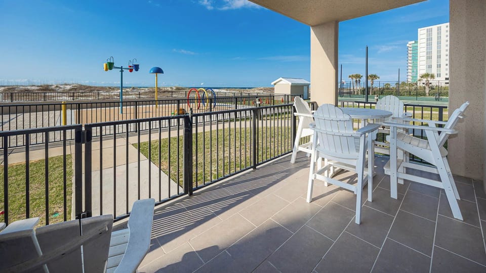 Relax at the outdoor patio area, enjoying views of the splash park, beach, and pool area just steps from your door