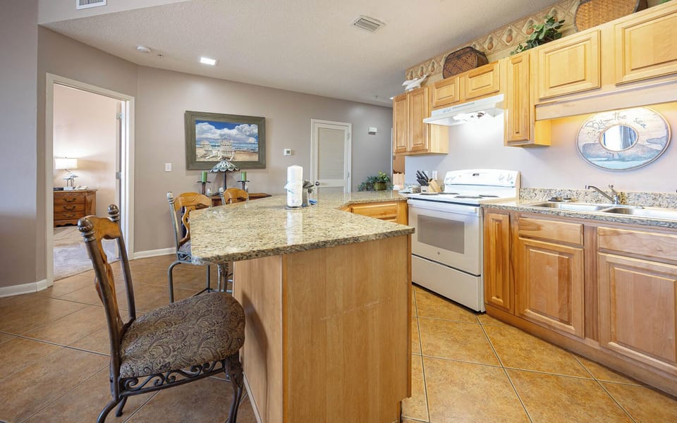 Prepare meals easily in the spacious kitchen with granite countertops and seating at the bar for casual dining
