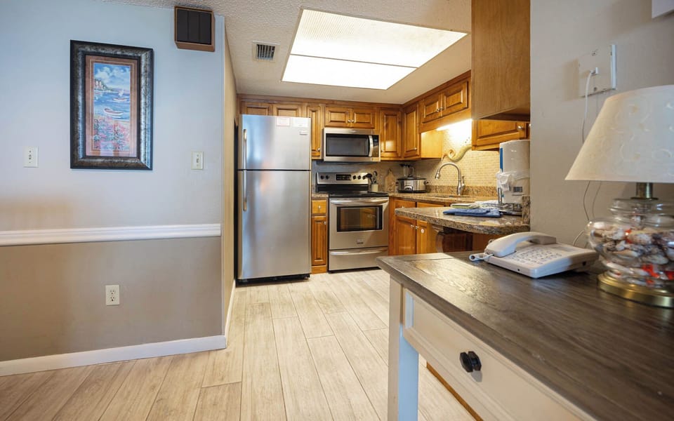 The kitchen features granite countertops, stainless appliances, and a cozy dining area, perfect for a delightful meal