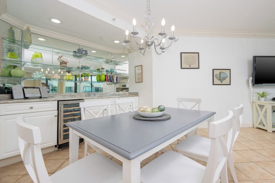 Gather around the stylish table for a delightful evening, surrounded by charming decor and serene ambiance