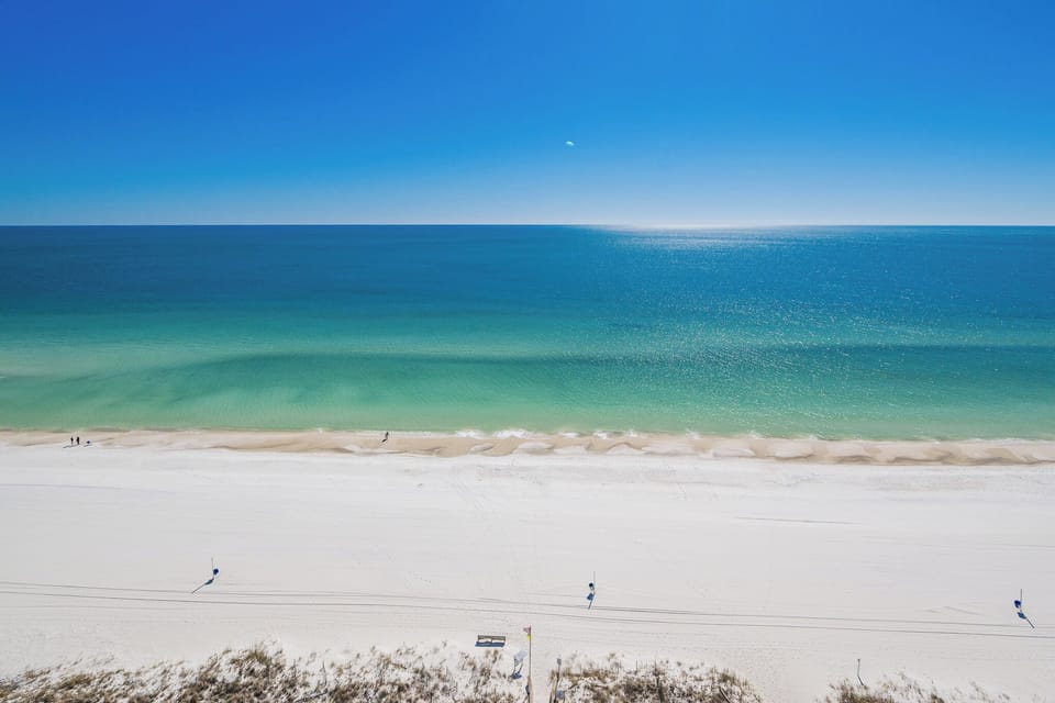 Capture a beachfront sunset over the water from your west corner balcony