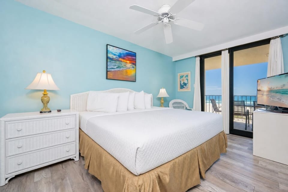 Calm blue walls frame your king master suite with relaxing beach views from the balcony