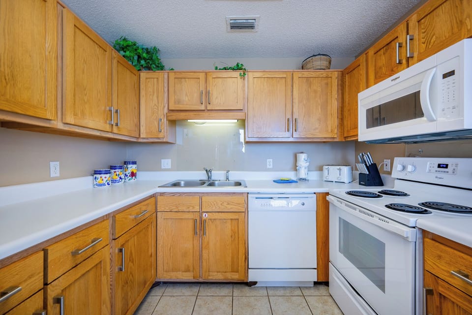 Wood cabinets surround you as you prepare fresh meals with ease in this cozy kitchen space