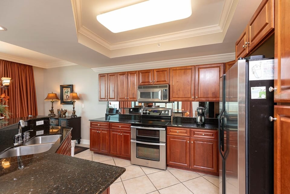Prepare meals in this kitchen with elegant cabinetry, stainless appliances, and spacious countertops
