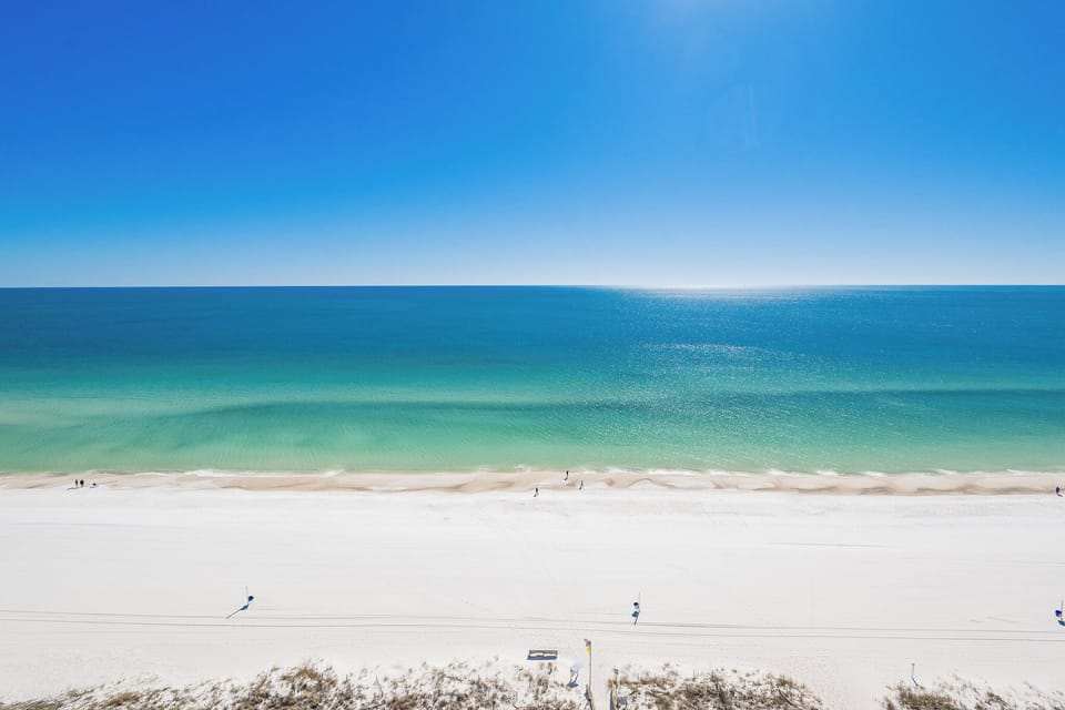 Look out over the sparkling coast from your balcony as gentle waves meet the shore below