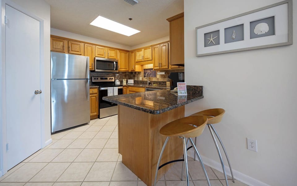Enjoy cooking in this kitchen with stainless appliances, granite countertops, and a cozy breakfast bar