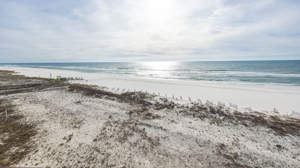 Gaze at the serene waters and soft shoreline, perfect for beach walks and relaxation under the sun