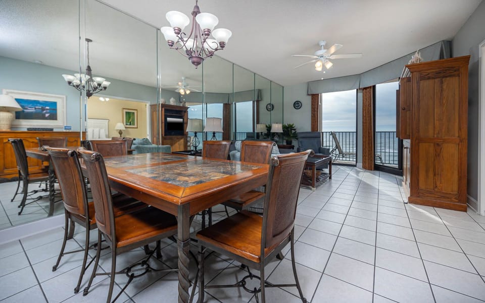 Gather around the wooden dining table, enjoying views and a spacious layout perfect for relaxation and meals together