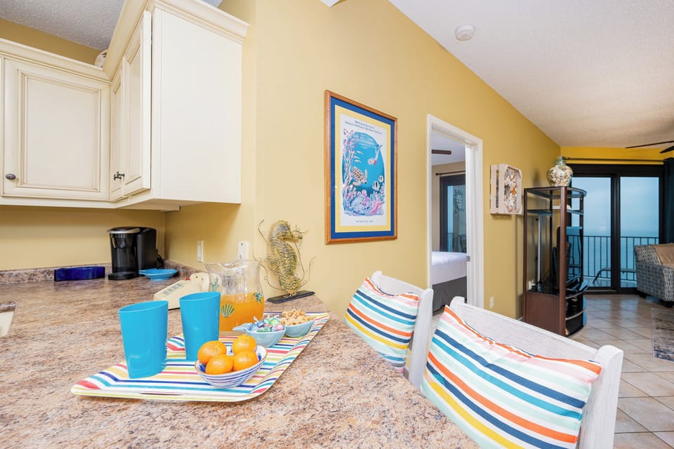 Savor refreshing drinks at the colorful bar, surrounded by vibrant decor and a welcoming atmosphere